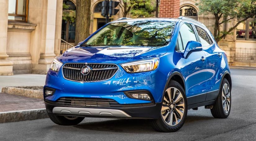 A blue 2019 Buick Encore is parked on a city street.