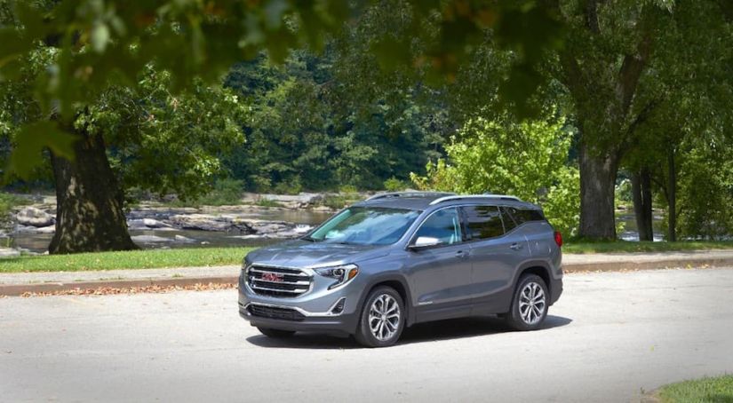 A gray Terrain parked in front of a river after winning 2019 GMC Terrain vs 2019 Ford Escape