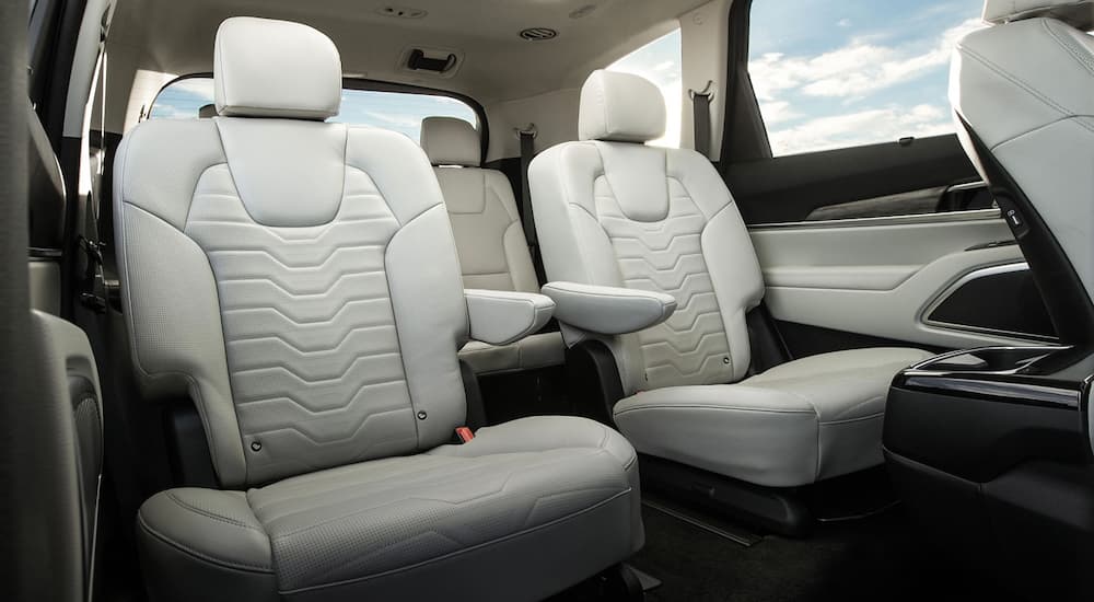 The white interior of the 2020 Kia Telluride is shown featuring the two back rows of seating.