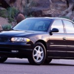 A black 2004 Buick Regal GS is in front of rocks.