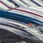 A row of cars is shown from an angle featuring the hoods.