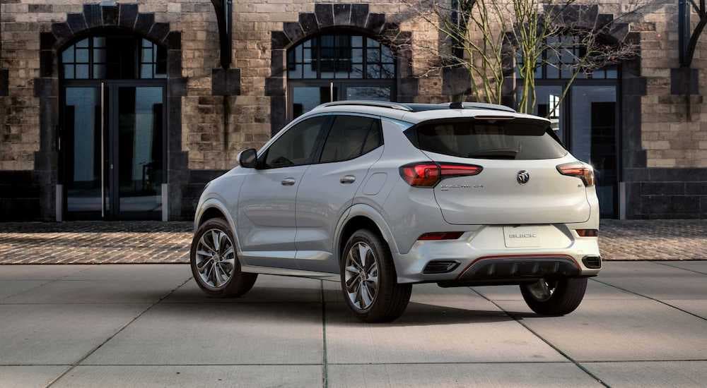 The 2020 Buick Encore is parked in front of an old brick building. 