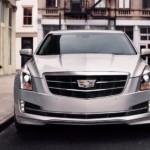 A silver 2019 Cadillac ATS is parked on a city street after leaving the Cadillac dealership.