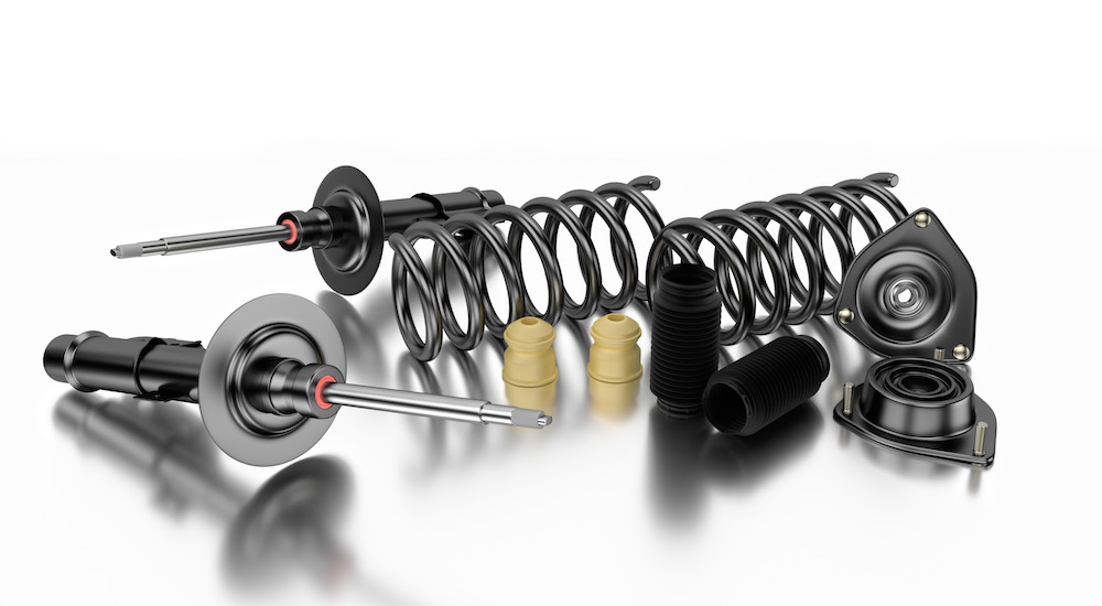 Car struts, springs, and bump stops are shown on a white background.