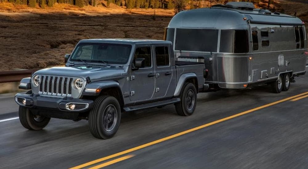 A grey 2020 Jeep Gladiator is towing an Airstream.