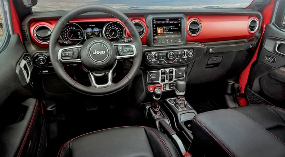 The red and black interior of a 2020 Jeep Gladiator is shown.