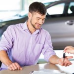 A man is at a dealer buying a car.