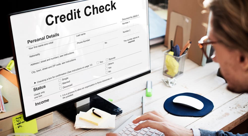 A credit check is shown on a computer, which is a step in the process for bad credit car finance.