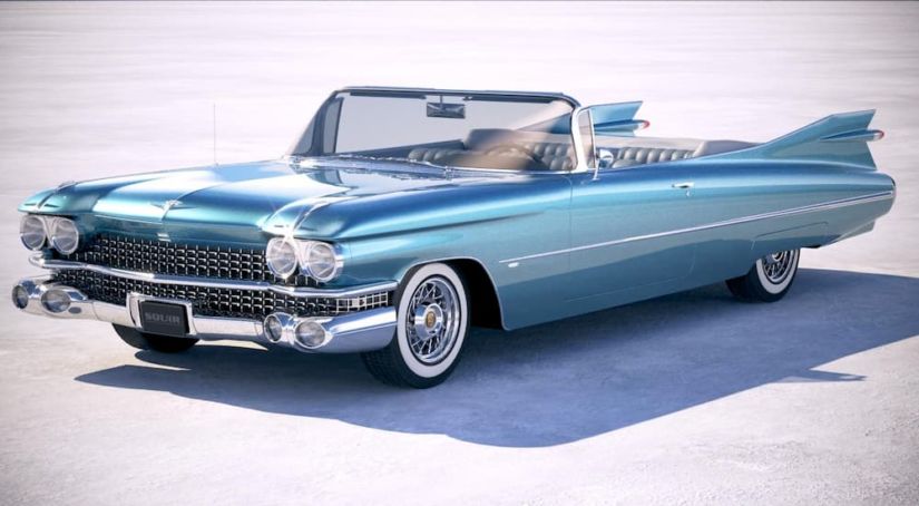 A blue 1959 Cadillac Eldorado is parked on a desert flats.