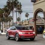 In current auto news, the Volkswagen ID. prototypes are shown downtown near the beach.