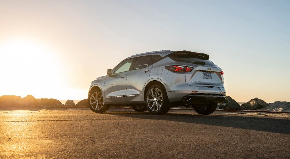 A silver 2019 Chevy Blazer, not yet available as an option for used cars, is parked in an open area with a low sun.