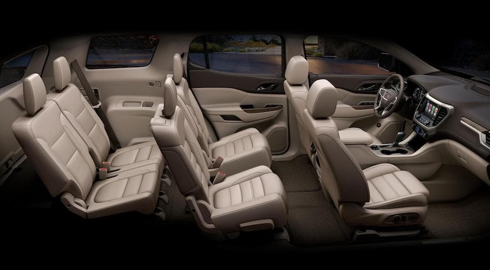The inside of the GMC Acadia is shown with tan color seats.
