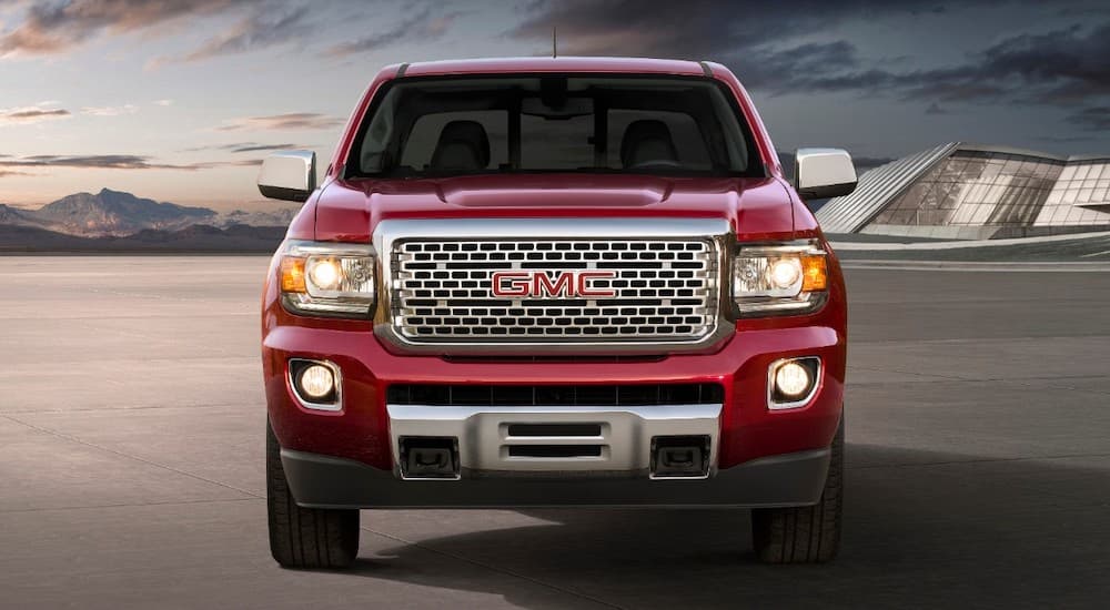 A red 2019 GMC Canyon, which wins when comparing the 2019 GMC Canyon vs 2019 Chevy Colorado for style, is shown from the front.