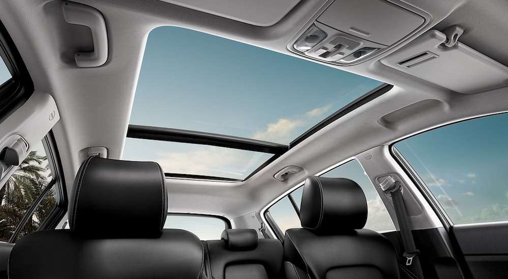 A look at the white interior of the 2020 Kia Sportage with a sunroof. 
