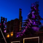 The steel factory is lit up at night near a Chevy dealer in Bethlehem, PA.