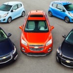 Five 2014 Chevy cars are parked together.