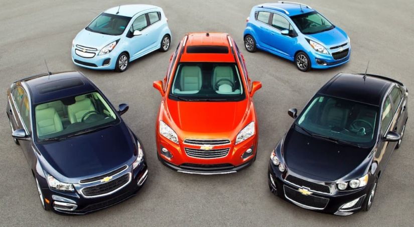 Five 2014 Chevy cars are parked together.