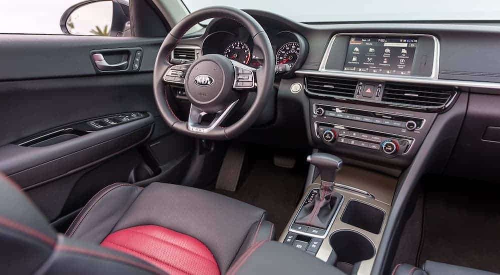 The front black and red leather interior with a touchscreen, and other high tech features are shown. 