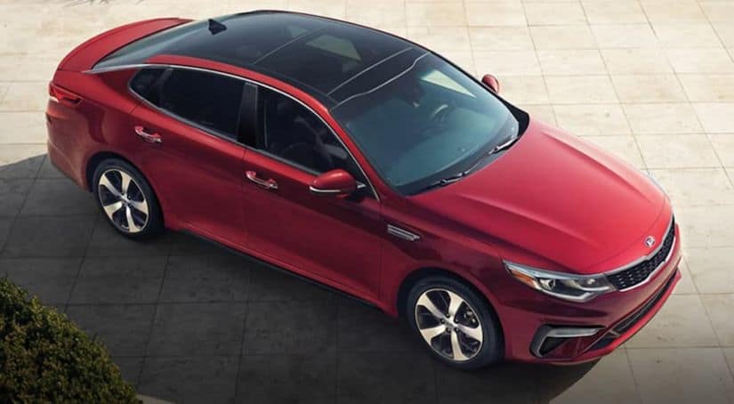 A bird's eye view of a red 2020 Kia Optima parked.