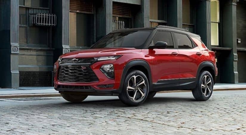 A red 2021 Chevy Trailblazer is parked on a cobble city street.