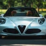 The front end of a white Alfa Romeo 4C Spider.