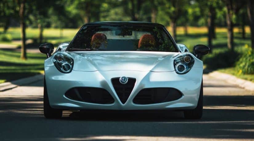 The front end of a white Alfa Romeo 4C Spider.