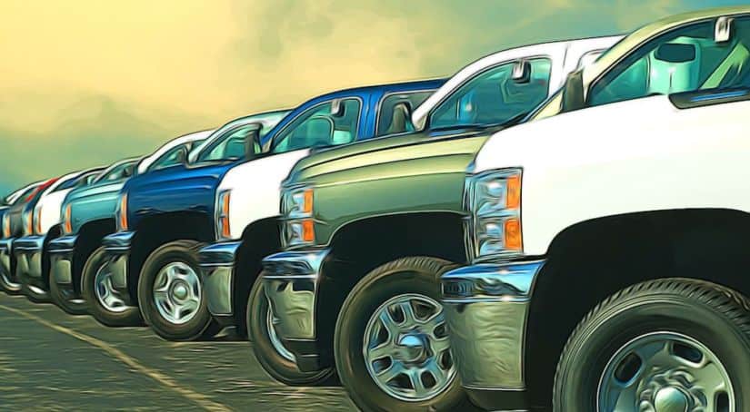 A row of used trucks for sale is shown.