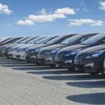 A row of used cars on a car lot.