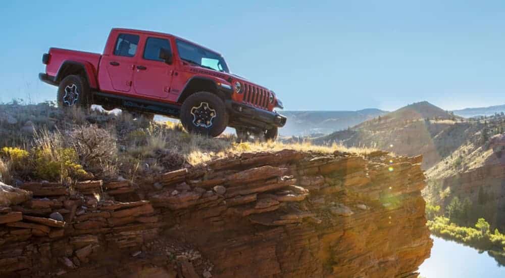 A 2020 Jeep Gladiator is parked on a rock hill looking over a valley. 
