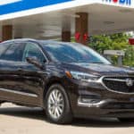 A used Buick SUV is filling up at a gas station.