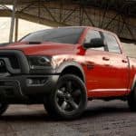 A red 2019 Ram 1500 Classic is parked with a city overhang behind it.