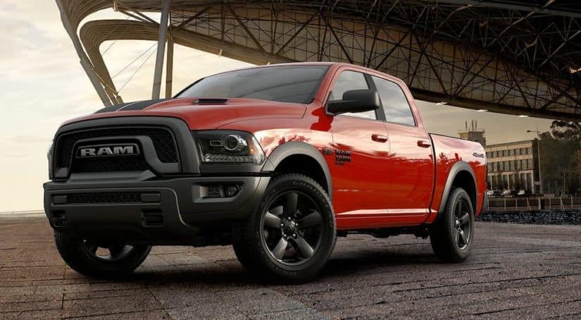 A red 2019 Ram 1500 Classic is parked with a city overhang behind it.