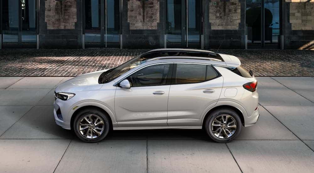 A silver 2020 Buick Encore GX is parked on a cement driveway.