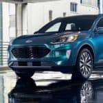 A blue 2020 Ford Escape, which wins when comparing the 2020 Ford Escape vs 2019 Ford Escape, is parked in a wet parking garage.