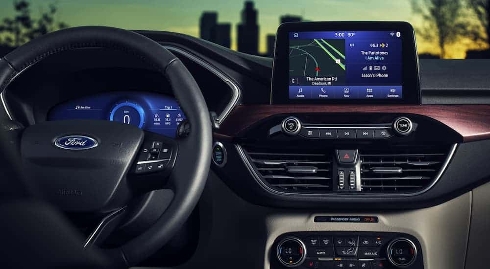 A close up of the infotainment system and the drivers display inside of a 2020 Ford Escape is shown.