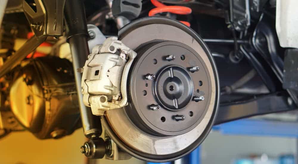 A close up of brake parts on a car. 