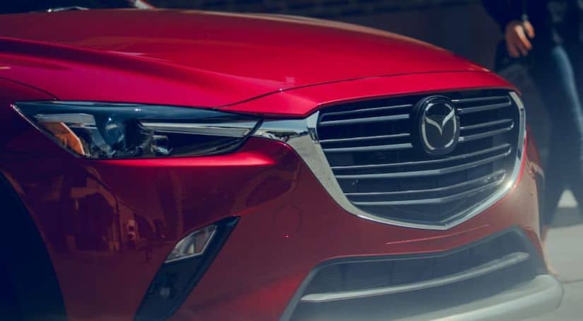 A close up of the front end of one of Mazda's top selling vehicles, a red CX-3.