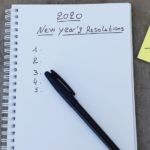 A pen is on a piece of paper that says "2020 New Years Resolution" on it.