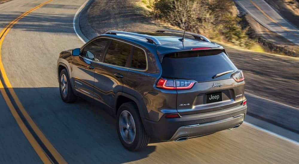 A look at a grey 2020 Jeep Cherokee from above driving on a winding road.