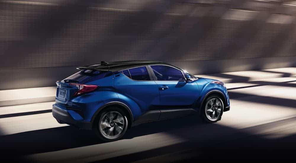 A blue 2020 Toyota C-HR is driving through a tunnel.