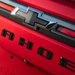 A close up of the black Chevy logo and Tahoe badging on the all-new 2021 Chevy Tahoe is shown.