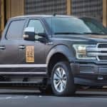 An all-electric Ford F-150, popular in current auto news, is shown in grey.
