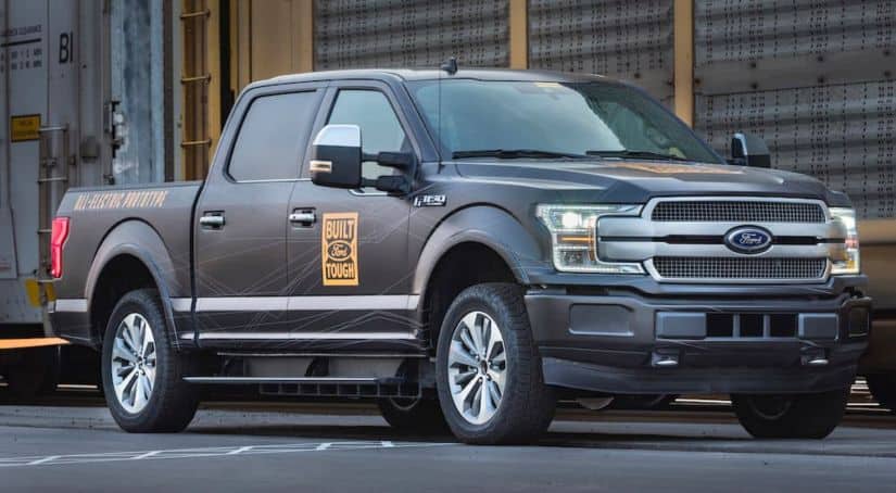 An all-electric Ford F-150, popular in current auto news, is shown in grey.