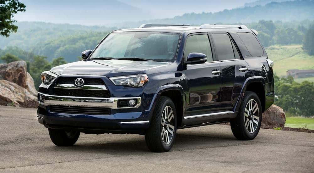 A blue 2018 Toyota 4Runner, which is popular among used SUVs, is parked with hills in the background.