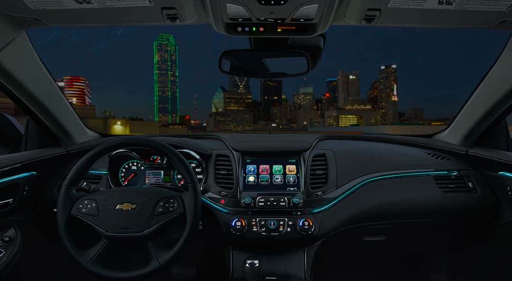 The black interior and blue accents are shown on a 2020 Chevy Impala.