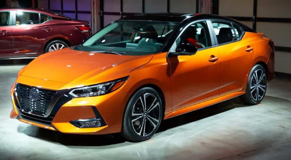 An orange 2020 Nissan Sentra is shown at a release showcase. 