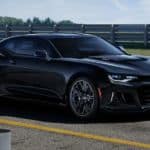 A black 2021 Chevy Camaro is parked on the race track after winning the 2021 Chevy Camaro vs 2021 Ford Mustang performance showndown.