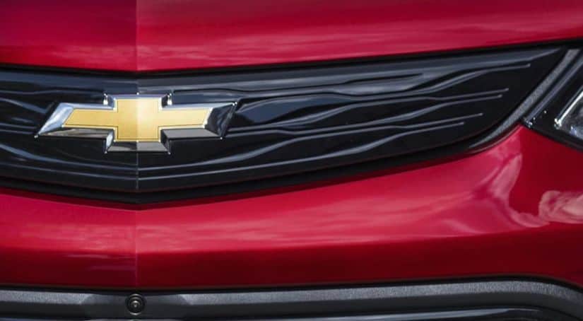 A close up of the gold Chevy logo is shown on a black grille.