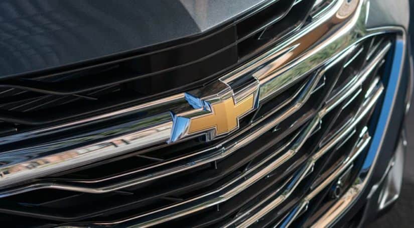 A close up of the Chevy logo on a gray vehicle.