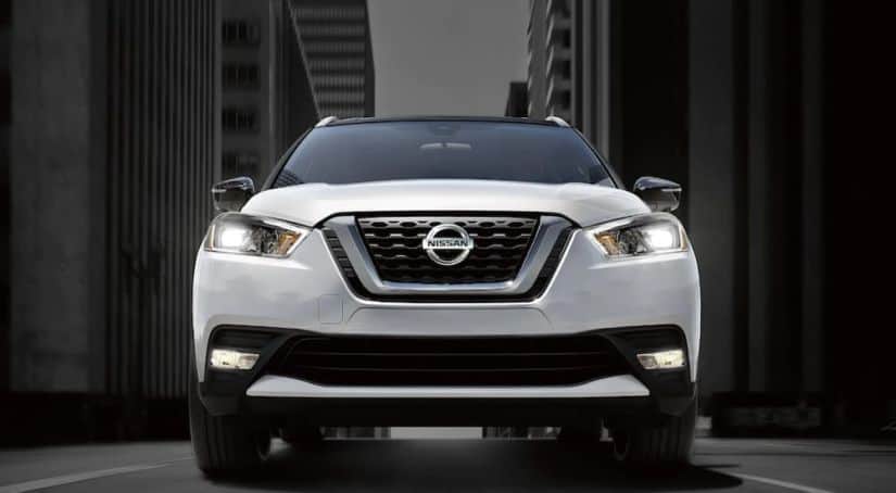 A close up of a white Nissan Kick's front grille and logo is shown.